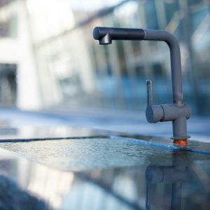 grey metal pipe on grey wooden table